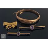 Three 9ct brooches to include a bow and two amethyst set examples, with a 9ct hinged bangle, total