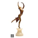 A 1930s patinated spelter figure of a dancing lady with arms raised and leg kicked back, in a