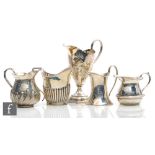 Five assorted hallmarked silver assorted cream jugs to include a Georgian helmet example with