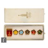 A cased set of six Moscow Olympic enamelled badges, five relating to the modern pentathlon.