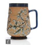 A late 19th Century Doulton Lambeth mug decorated with raised foliate scrolls framing a central