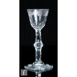 An 18th Century drinking glass circa 1785, the round funnel bowl engraved to the upper border with