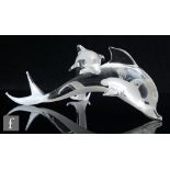 A 20th Century glass figure, depicting a small dolphin set across the back of a larger dolphin,
