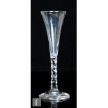 An 18th Century champagne glass circa 1785, the slender drawn trumpet bowl above a hollow