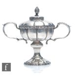 A hallmarked silver novelty miniature twin handled trophy cup and cover with daisy head details to