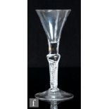 An 18th Century composite stem drinking glass, circa 1750, the trumpet bowl with plain section