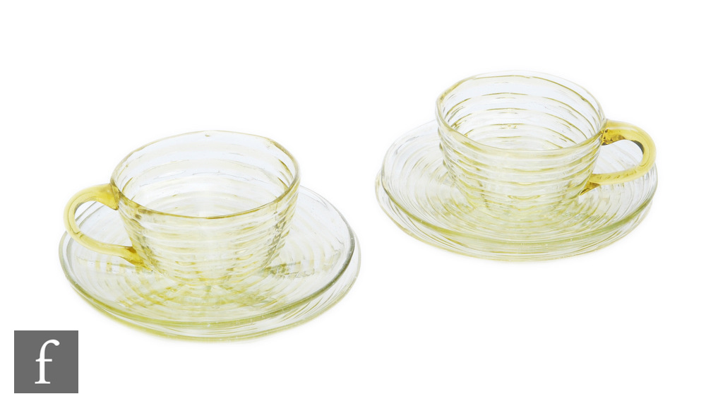 A group of 1930s Gray-Stan glass cups and saucers, comprising two cups and four saucers, decorated