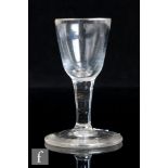 An 18th Century toasting glass, circa 1745, the deceptive round funnel bowl above a plain stem