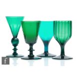 A group of four 19th Century Bristol green drinking glasses to comprise a fluted round funnel bowl