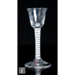 An 18th Century drinking glass, circa 1770, the pointed round funnel bowl with basal flutes above
