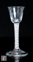 An 18th Century drinking glass, circa 1770, the pointed round funnel bowl with basal flutes above