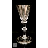 An 18th Century balustroid wine glass circa 1740, round funnel bowl above a double knopped plain