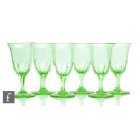 A set of six 19th Century green wine glasses, the bell form bowl with basal slice cut detail above a