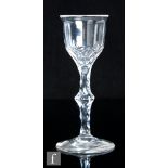 An 18th Century drinking glass, circa 1785, the flared ogee bowl with basal fleur de leys cuts above