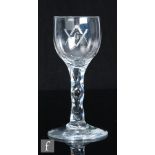 An 18th Century Masonic drinking glass, the ovoid bowl engraved with a letter G within the square