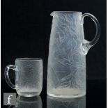 A 20th Century Czechoslovakian glass jug, of tapering cylinder form, the body engraved with a nude