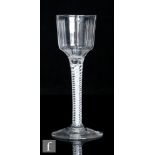 An 18th Century drinking glass circa 1760, the ogee bowl with pronounced vertical ribs above an