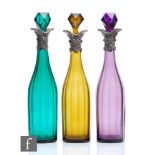 A set of three 19th Century decanters, circa 1850, the slice cut bottle form body rising to a