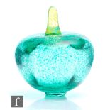 A 20th Century Kosta Boda glass paperweight, in the form of a stylised apple, decorated in a mottled