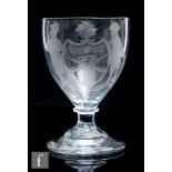An early 19th Century glass rummer, the ovoid bowl engraved with an armorial decorated with