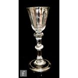An 18th Century balustroid wine glass circa 1740, round funnel bowl above a double knopped plain