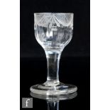 A small 18th Century drinking glass, the ogee bowl engraved with swags over a vertical fluted