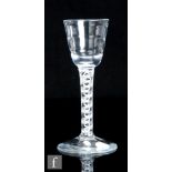 An 18th Century drinking glass, circa 1765, the round funnel Lynn bowl with four bands above a