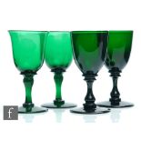 A group of four 19th Century Bristol green drinking glasses to comprise a pair of bell form bowls