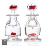 A pair of 19th Century Old English paperweight ink or scent bottles, possibly Richardsons, of footed