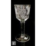 An 18th Century Goblet circa 1740, the large ogee bowl engraved with a Ho Ho bird and fruiting