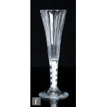An 18th Century Champagne or drinking glass, the tall funnel bowl with heavy vertical flutes above