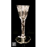 An 18th Century wine glass circa 1780, the round funnel bowl engraved with a foliate border above