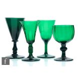 A group of four 19th Century Bristol green drinking glasses to comprise a conical bowl with basal