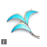 A Scandinavian silver spray brooch decorated with three pale blue stylised leaves, length 5cm.