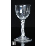 An 18th Century drinking glass, circa 1765, the planished ovoid bowl above a double series opaque