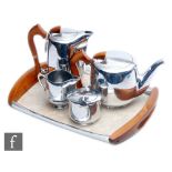 A mid 20th Century stainless steel Picquot Ware four piece tea set and conforming tray with shaped