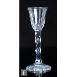 An 18th Century drinking glass, circa 1785, the round funnel bowl with basal cutting above a