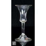 An 18th Century drinking glass, circa 1745, the bell bowl above a plain stem with basal knop and