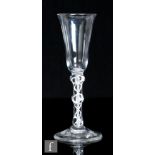 An 18th Century drinking glass, circa 1770, the trumpet bowl over a double series opaque twist