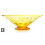A 1930s Thomas Webb & Sons footed amber glass bowl, engraved with lilies and leaves, acid marked,