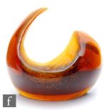 An Amy Johnson kiln cast sculptural glass form of an arched crescent with high polished exterior and