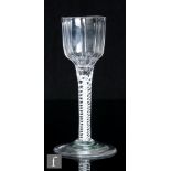 An 18th Century drinking glass, circa 1770, the round funnel bowl with heavy vertical moulding,