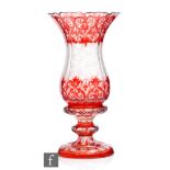 A 19th Century Bohemian crystal glass vase of footed tulip form with facet knopped stem, ruby