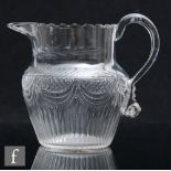 A late Georgian Irish clear cut crystal water jug, circa 1800, the shouldered ovoid body with