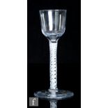 An 18th Century drinking glass, circa 1765, the ogee bowl over a double series opaque twist stem