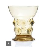 An Arts and Crafts style Dutch Revivalist green glass goblet, in the style of Harry Powell for