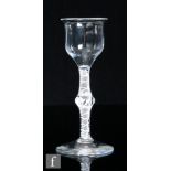 An 18th Century drinking glass, circa 1765, the ogee bowl over a double series opaque twist stem