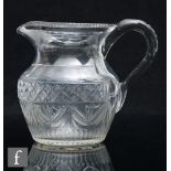 A late Georgian Anglo-Irish water jug, circa 1800, the swollen ovoid body with flared rim,