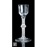 An 18th Century drinking glass circa 1765, the ogee bowl above an opaque twist stem with multiple