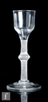 An 18th Century drinking glass circa 1765, the ogee bowl above an opaque twist stem with multiple